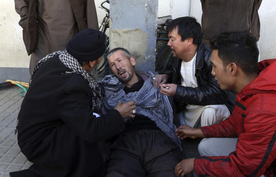 <p>A distraught man is cared for outside a hospital following a suicide attack in Kabul, Afghanistan, Thursday, Dec. 28, 2017. (Photo: Rahmat Gul/AP) </p>