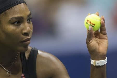 Serena Williams of the U.S. holds a new ball before serving to her sister and compatriot Venus Williams during their quarterfinals match at the U.S. Open Championships tennis tournament in New York, September 8, 2015. REUTERS/Carlo Allegri