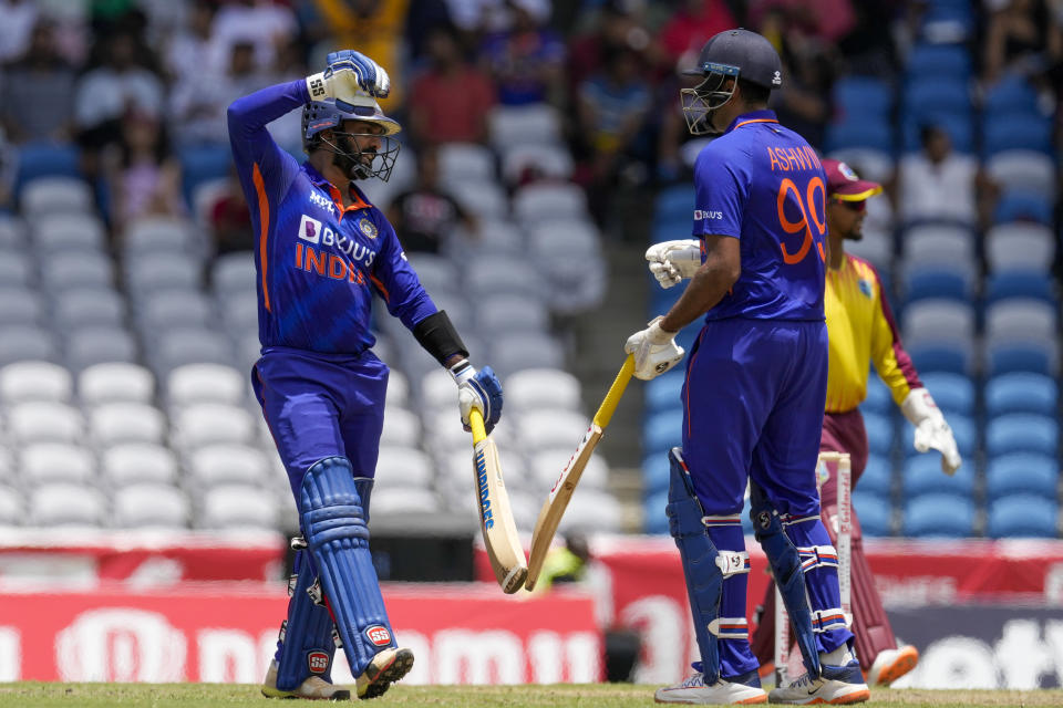 India's Dinesh Karthik, left, celebrates with Ravichandran Ashwin during their partnership against Wes Indies in the first T20 cricket match at Brian Lara Cricket Academy in Tarouba, Trinidad and Tobago, Friday, July 29, 2022. (AP Photo/Ricardo Mazalan)