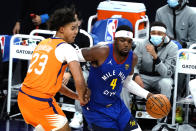 Denver Nuggets forward Paul Millsap drives on Phoenix Suns forward Cameron Johnson (23) during the first half of an NBA basketball game Friday, Jan. 22, 2021, in Phoenix. (AP Photo/Rick Scuteri)