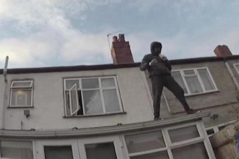 Fyle on a roof in South Norwood as he tries to evade police after the murder