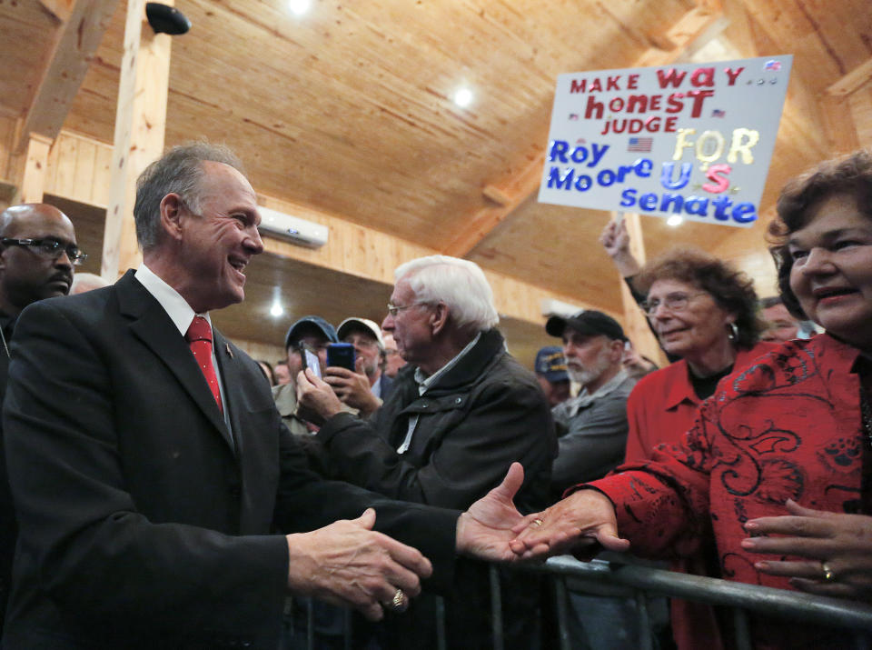 U.S. Senate candidate Roy Moore greets supporter before he speaks at a campaign rally on Dec. 11 in Midland City, Ala. (AP Photo/Brynn Anderson)