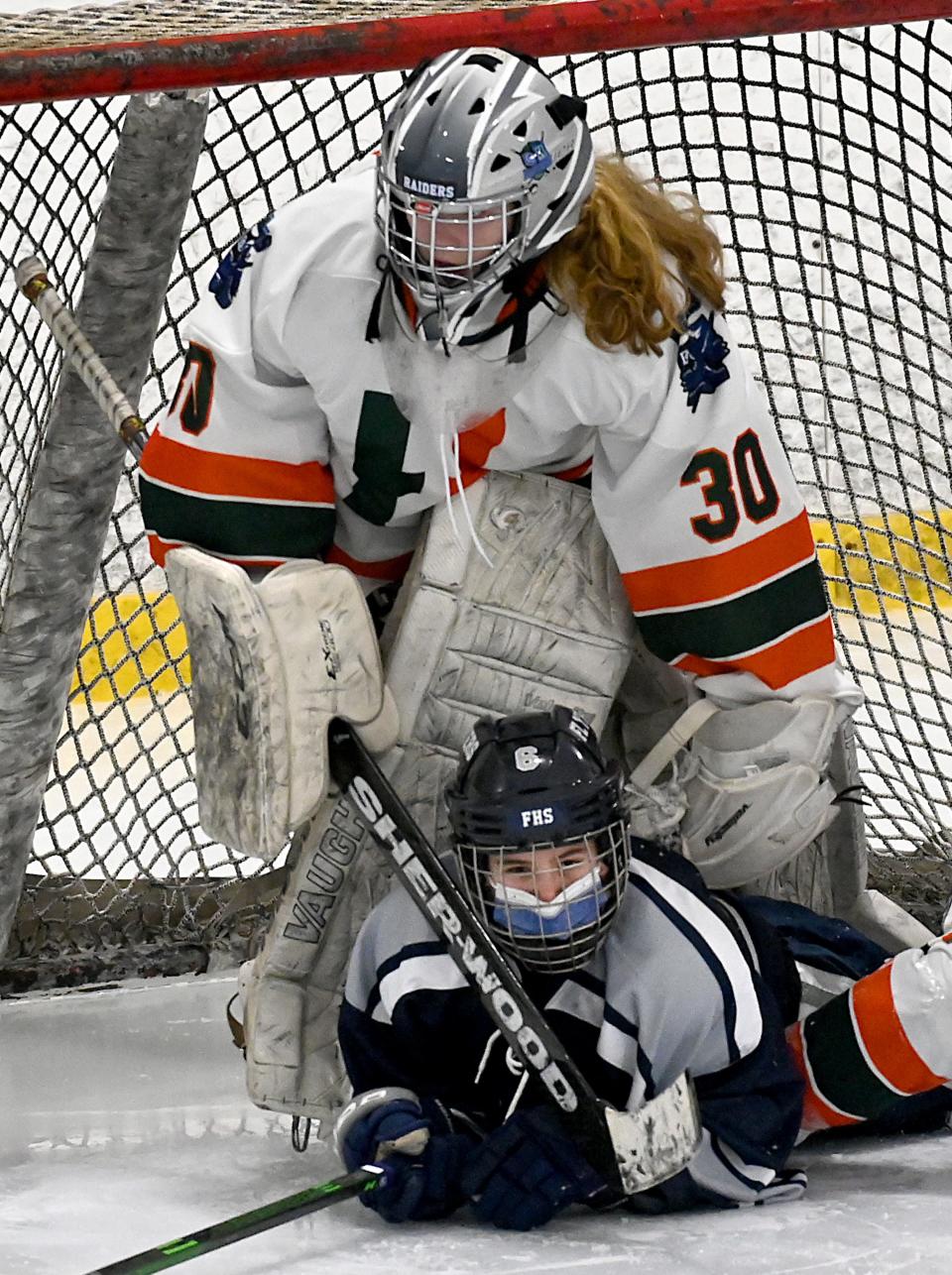 Framingham's Zoe Yale crashes into Hopkinton/Dover-Sherborn goalie Morgan Fraser during the second period at New England Sports Center in Marlborough, Jan. 15, 2021. 