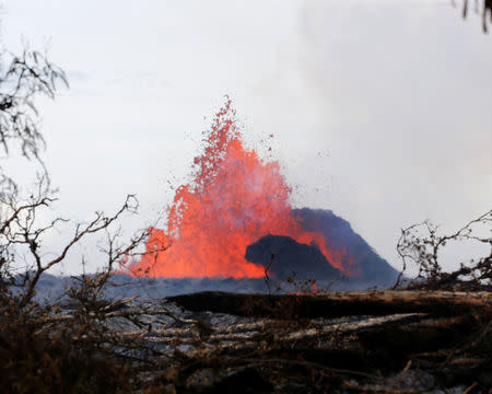 A volcanic fissure spurts molten rock into the air near Nohea Street, in the Leilani Estates, near Pahoa, Hawaii, U.S., May 27, 2018. REUTERS/Marco Garcia