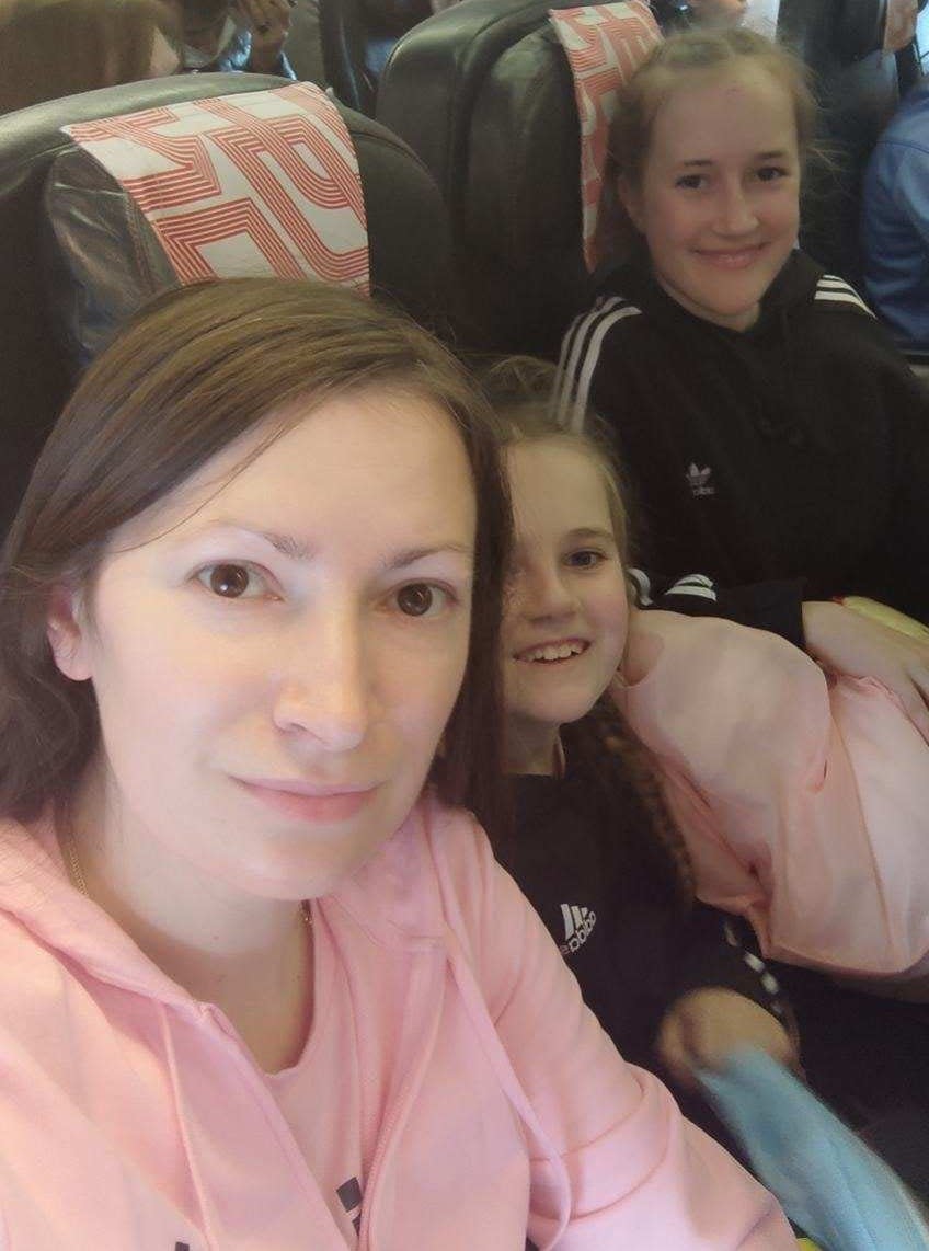 Tania and her girls Ksyusha and Mira on one of five flights they had to take to get from Ukraine to Oak Ridge.
