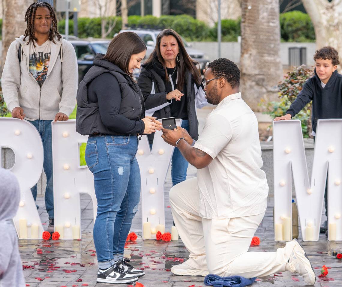 Jovontue Dorsett, 36, proposes to Shelby Ray, 31, at Capitol Park’s World Peace Rose Garden on Sunday, March 3, 2024. Cameron Clark/cclark@sacbee.com