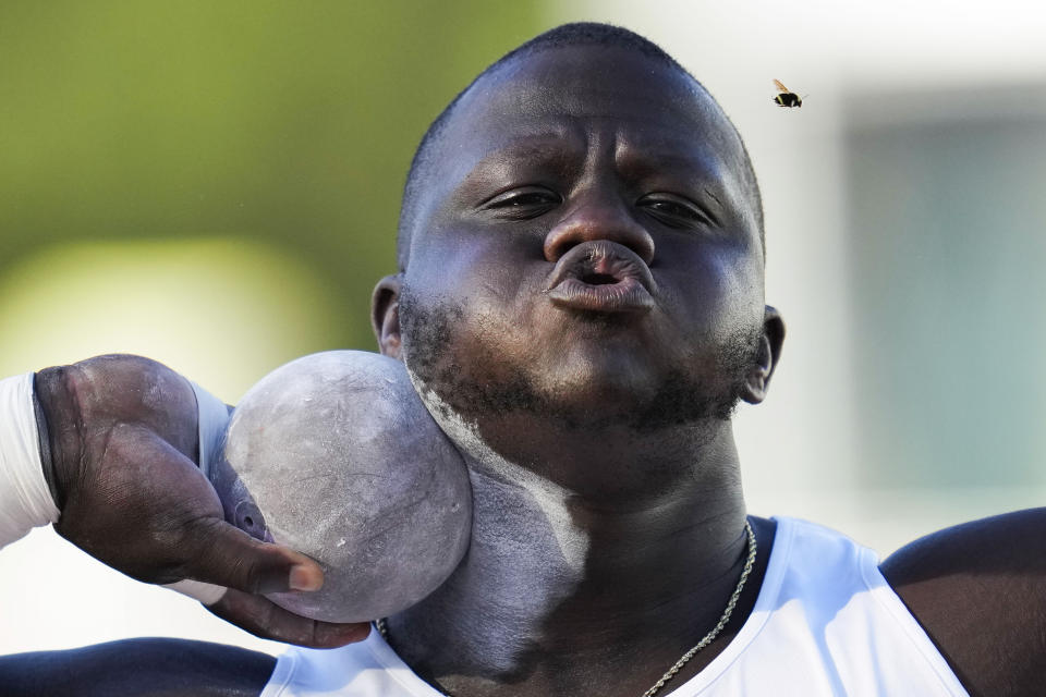 Josh Awotunde blows away a bug as he competes in the men's shot put during the U.S. track and field championships in Eugene, Ore., Sunday, July 9, 2023. (AP Photo/Ashley Landis)