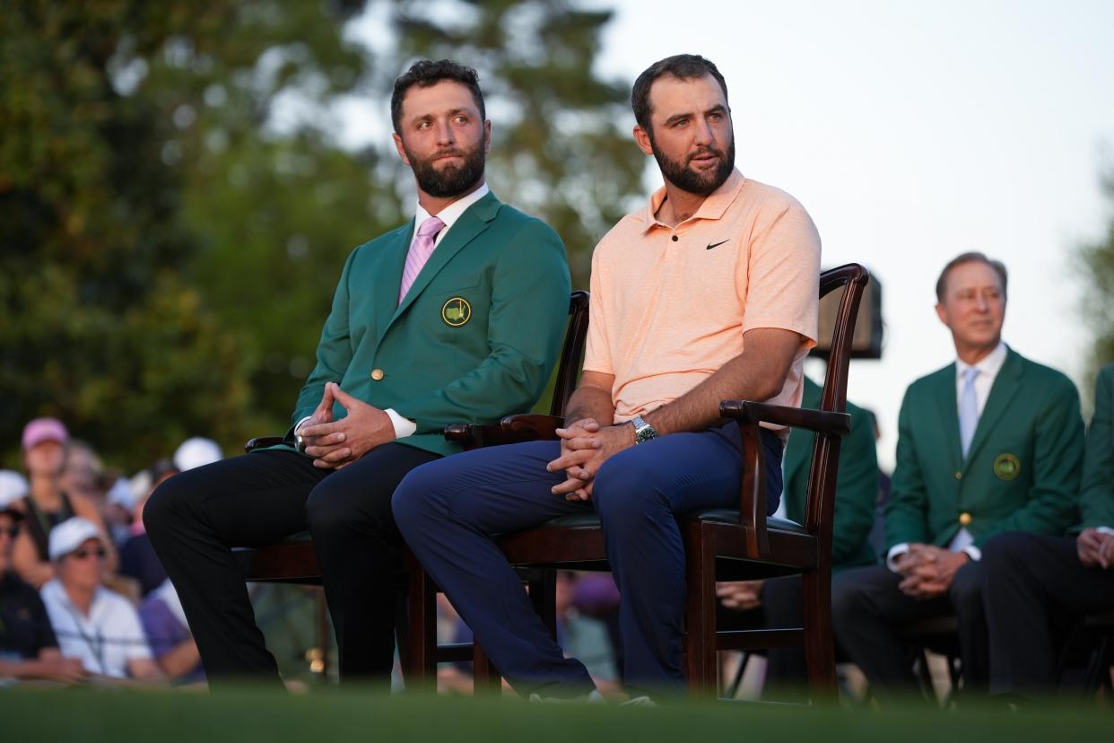 Scottie Scheffler sits with Jon Rahm, of Spain, at the green jacket ceremony after winning the Masters golf tournament at Augusta National Golf Club Sunday, April 14, 2024, in Augusta, Ga. . (AP Photo/Matt Slocum)