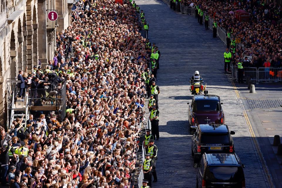 King Charles III pass crowds ahead of the cortege carrying Queen Elizabeth II's coffin from the Palace of Holyroodhouse to St Giles Cathedral