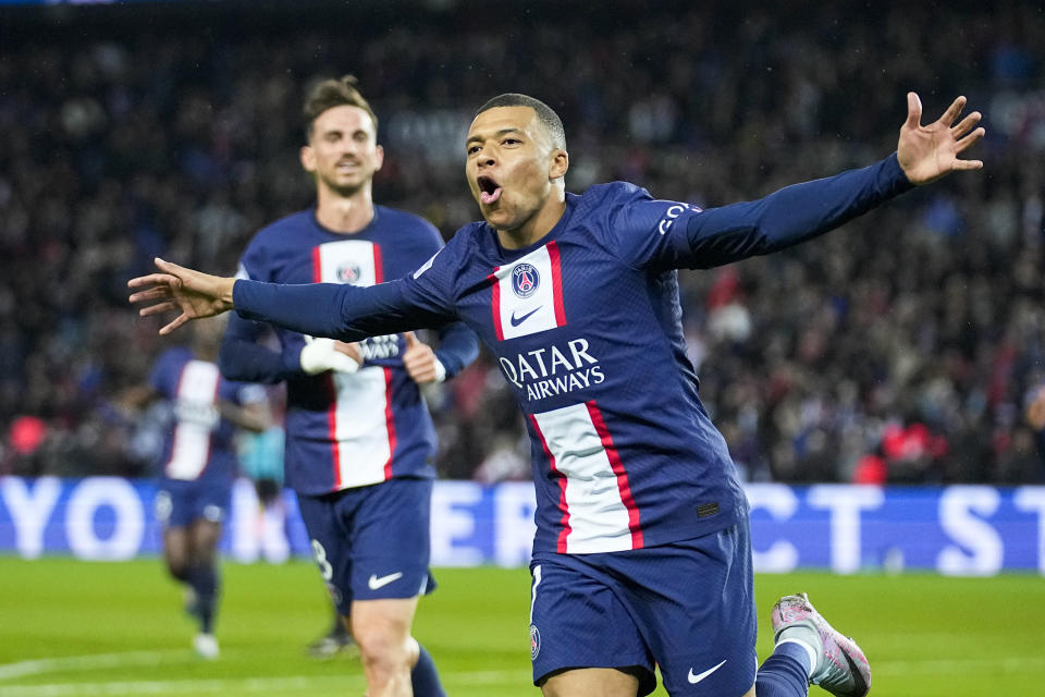 PSG's Kylian Mbappe celebrates scoring his side's opening goal during the French League One soccer match between Paris Saint Germain and Lens at Parc des Princes stadium in Paris, France, Saturday, April 15, 2023. (AP Photo/Michel Euler)