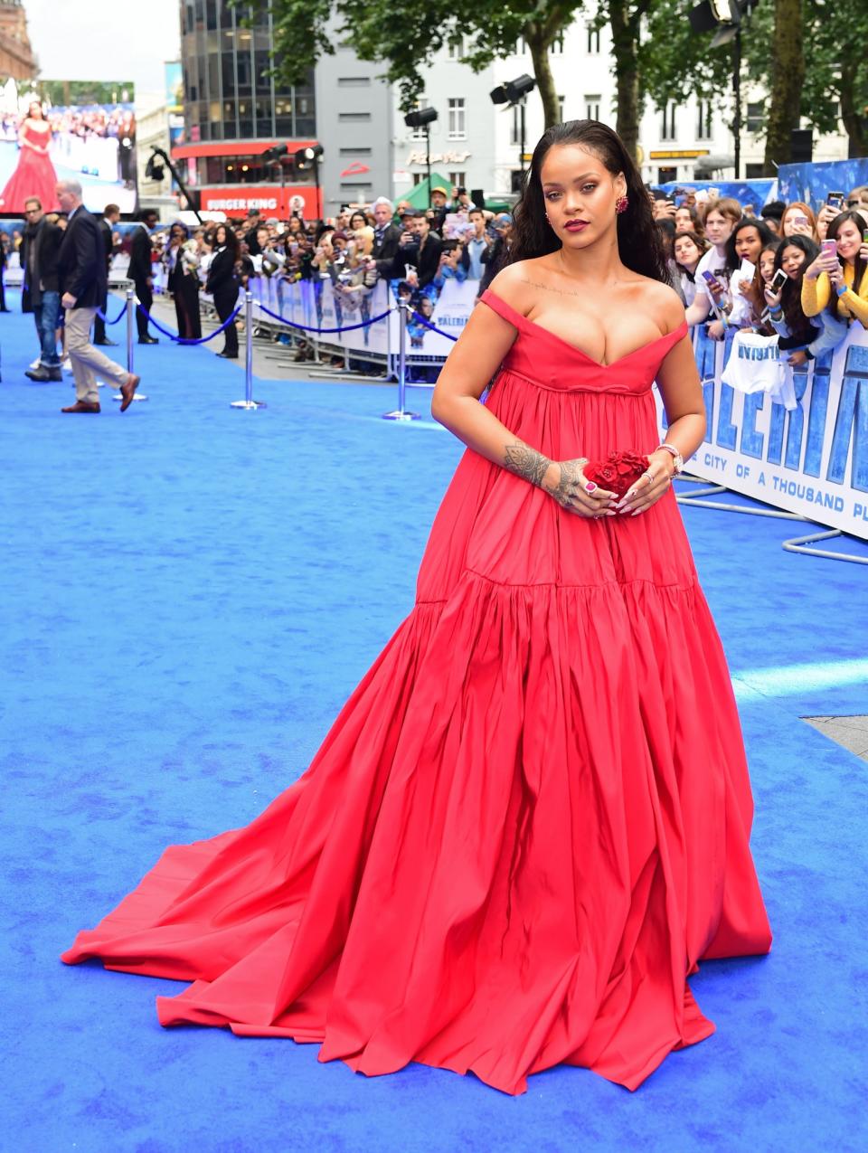 <p>Rihanna went for a couture design by Giambattista Valli once again, hitting the blue carpet in an off-the-shoulder red gown and carrying a rose-hued Jimmy Choo clutch.<br><i>[Photo: PA]</i> </p>