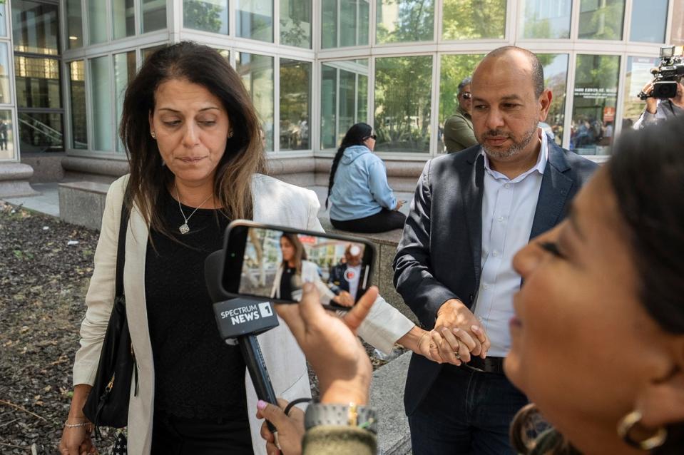 Nancy Iskander, left, holding the hand of her husband, Karim, leaves Van Nuys Courthouse on Monday, June 10, 2024, in Van Nuys, Calif. (Associated Press)