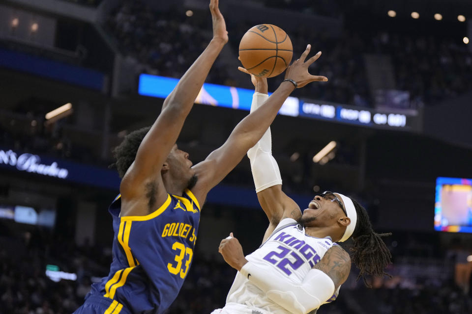 Sacramento Kings center Richaun Holmes (22) reacts as he is fouled by Golden State Warriors center James Wiseman (33) during the first half of an NBA basketball game on Sunday, Oct. 23, 2022 in San Francisco. (AP Photo/Tony Avelar)