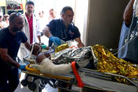 <p>Emergency workers use a trolley to take a person injured in an earthquake on the Greek island of Kos as they arrive for treatment on the island of Crete in Heraklion on July 21, 2017. (Photo: Costas Metaxakis/AFP/Getty Images) </p>