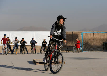 An Afghan young cyclist performs her tactics during an exercise in Kabul, Afghanistan November 15, 2016. REUTERS/Omar Sobhani