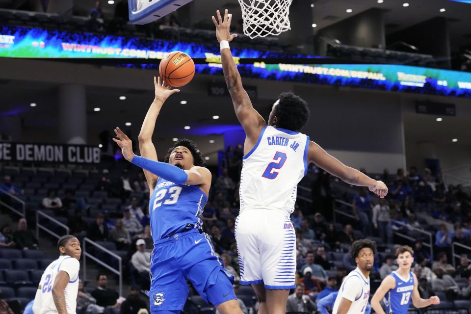 Creighton guard Trey Alexander, left, shoots against DePaul guard Chico Carter Jr., during the first half of an NCAA college basketball game in Chicago, Tuesday, Jan. 9, 2024. (AP Photo/Nam Y. Huh)