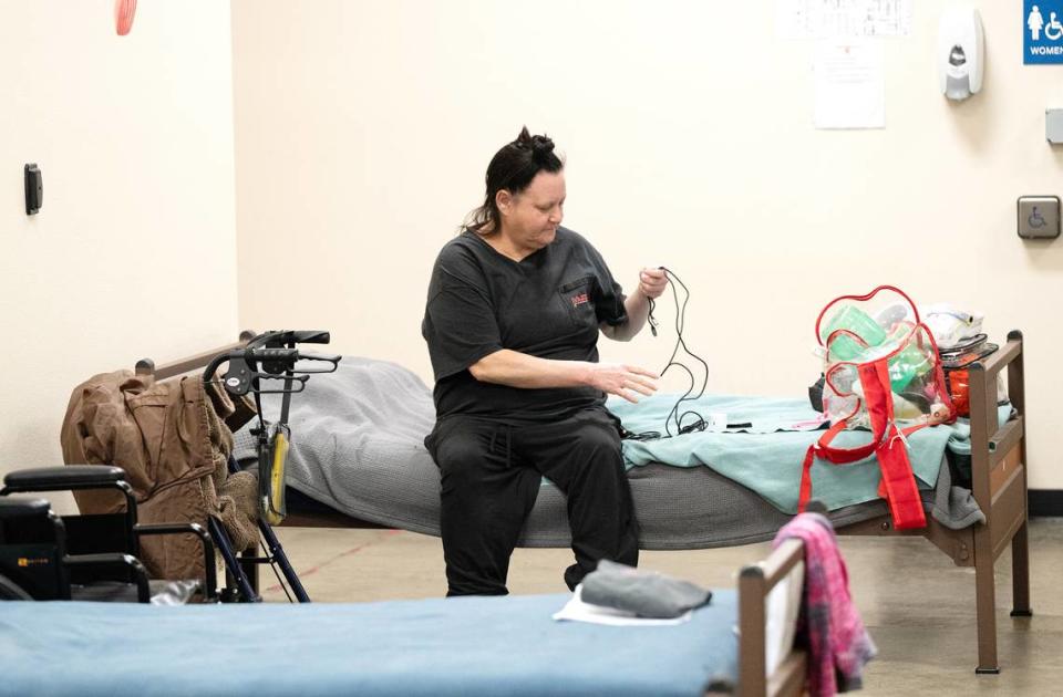 Michelle Alias, 46, organizes some of her things inside the 56-bed women’s dorm at Salvation Army Berberian Center in Modesto, Calif., Wednesday, Nov. 22, 2023.