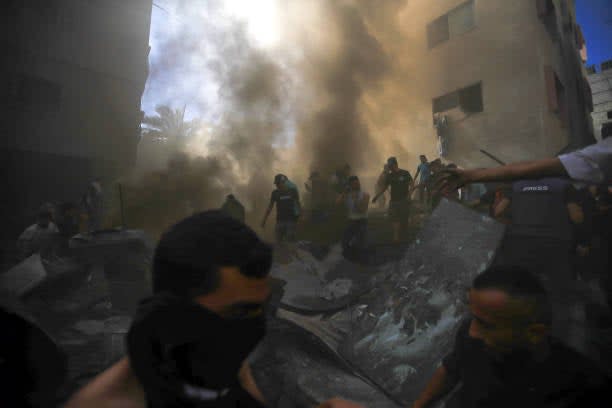 Civil defense teams and locals carry out search and rescue operations after an Israeli attack hits Shaqwra family apartment in Khan Yunis, Gaza on 6 November 2023 (AFP via Getty Images)