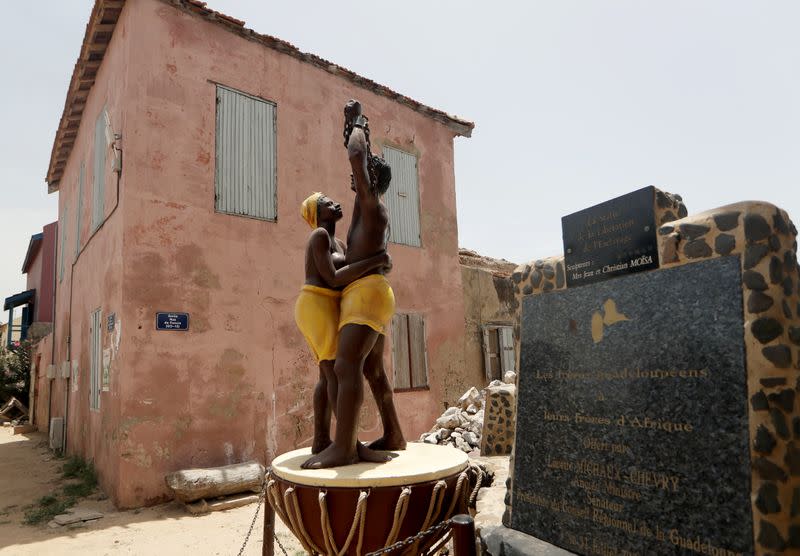 A statue stands in front of the House of Slaves museum on Goree Island