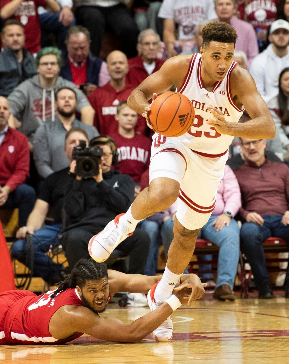 Indiana's Trayce Jackson-Davis (23) avoids being held by Nebraska's Derrick Walker (13) before starting a fast break during the first half of the Indiana versus Nebraska men's basketball game at Simon Skjodt Assembly Hall on Wednesday, Dec. 7, 2022.