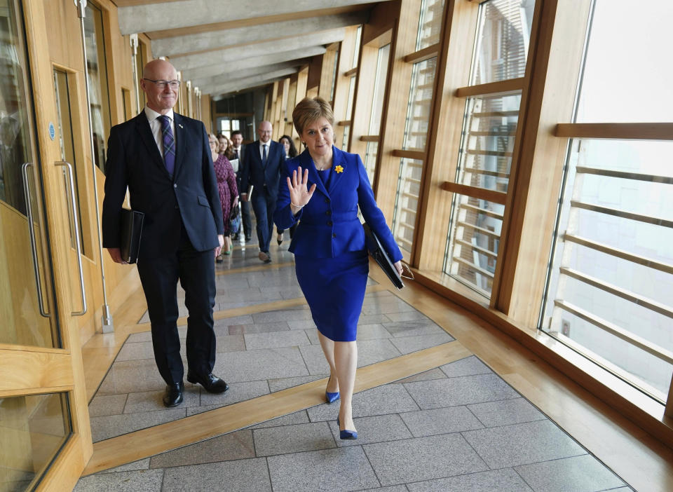 Deputy First Minister John Swinney, left and outgoing First Minister Nicola Sturgeon arrive for her last First Minster's Questions (FMQs) in the debating chamber of the Scottish Parliament in Edinburgh, Thursday March 23, 2023. ( Jane Barlow/PA via AP)