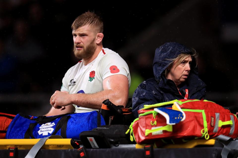 His day is done: George Kruis is carried off with a calf injury against the All Blacks: PA
