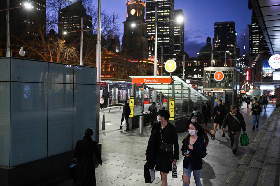 People with face masks walking around the Town Hall train station entrance in Sydney's CBD during the coronavirus pandemic.