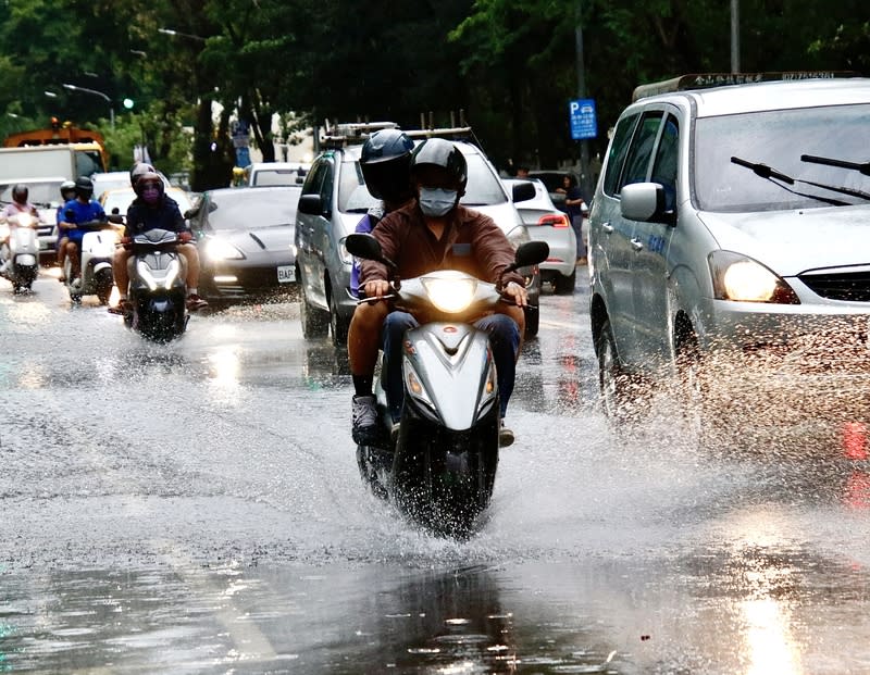 高雄強降雨致道路積水（1） 中央氣象署25日針對高雄地區發布豪雨特報，午後強 降雨也導致多處道路傳出積淹水情形。圖為高雄民眾 騎車行經積水路段，濺起大量水花。 中央社記者董俊志攝  113年4月25日 