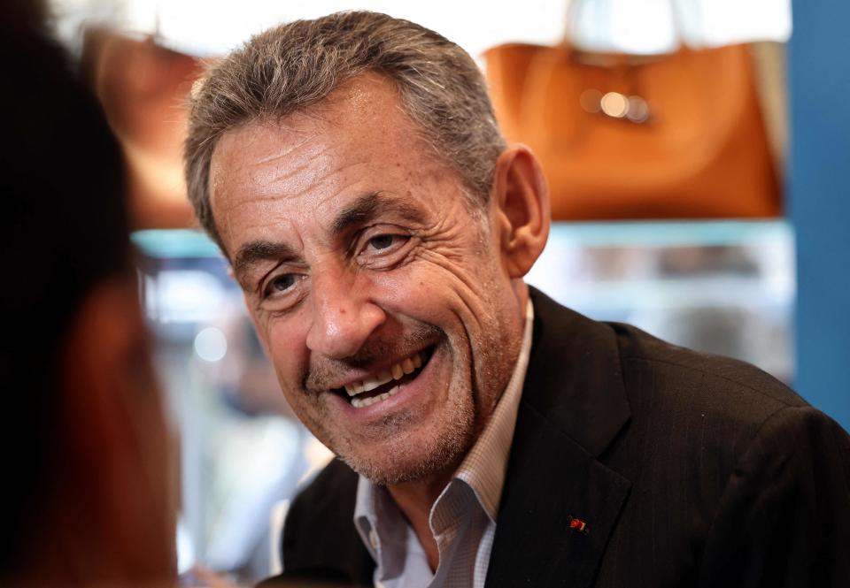 Former French president Nicolas Sarkozy speaks with his supporters last October during a signing session for his new book (AFP via Getty Images)