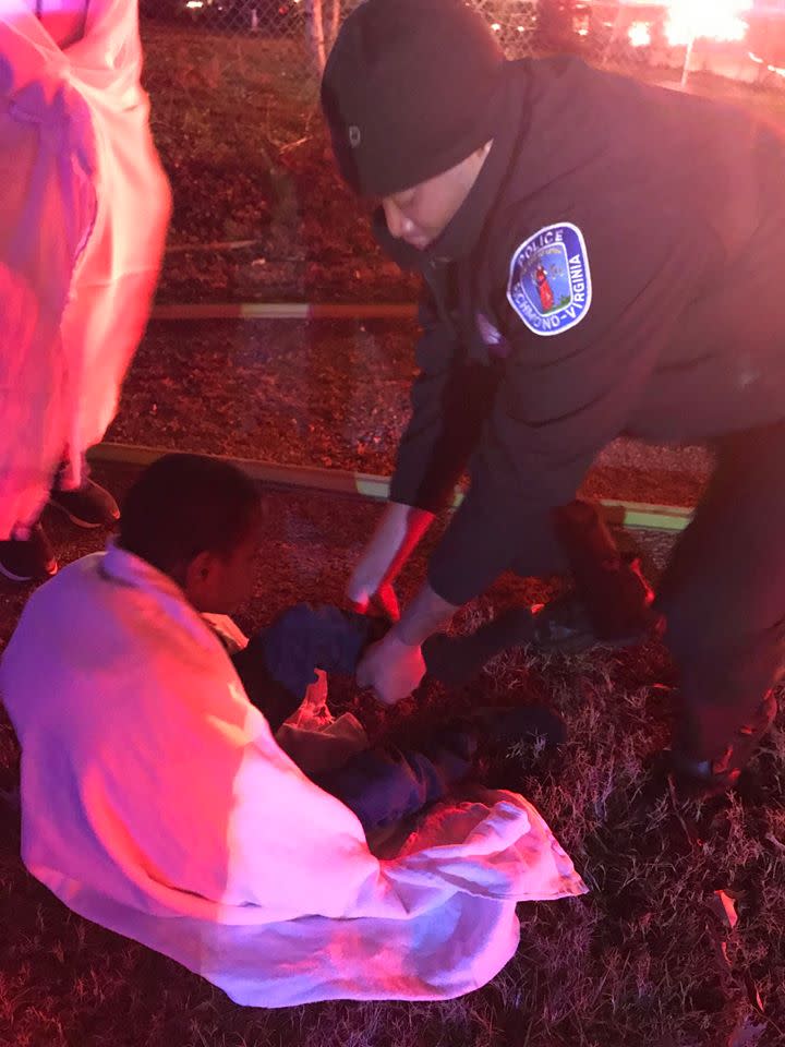 A Richmond, Va., police officer putting socks on a young boy during a house fire. (Photo: Facebook)