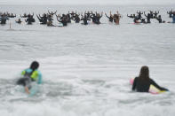 Surfers participate in a paddle out ceremony at "The Ink Well," a beach historically known as a surfing refuge for African Americans, to honor the life of George Floyd on Friday, June 5, 2020, in Santa Monica, Calif. Floyd, a black man, died after he was restrained in police custody on Memorial Day in Minneapolis. (AP Photo/Ashley Landis)