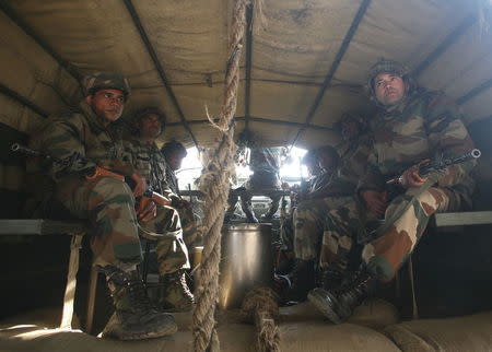 Indian army soldiers sit in a truck as they head towards the Indian Air Force (IAF) base at Pathankot in Punjab, January 3, 2016. REUTERS/Mukesh Gupta