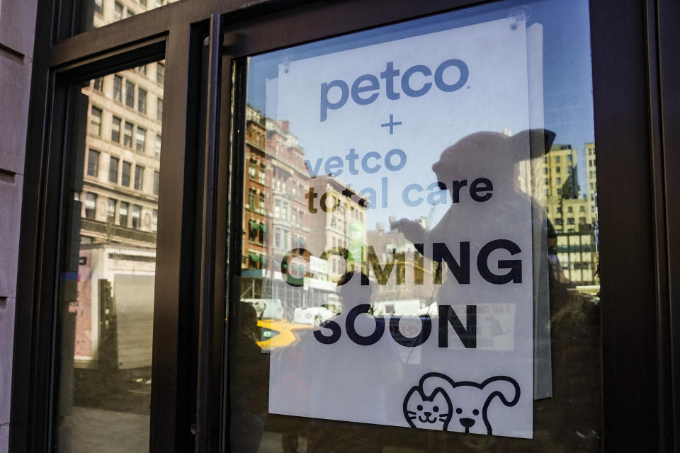 A doorway reflection shows Scabby, a giant inflatable rat used organized labor, setup in protest outside Petco on Wednesday March 29, 2023, in New York. For decades, inflatable rats like Scabby have been looming over union protests, drawing attention to construction sites or companies with labor disputes. (AP Photo/Bebeto Matthews)