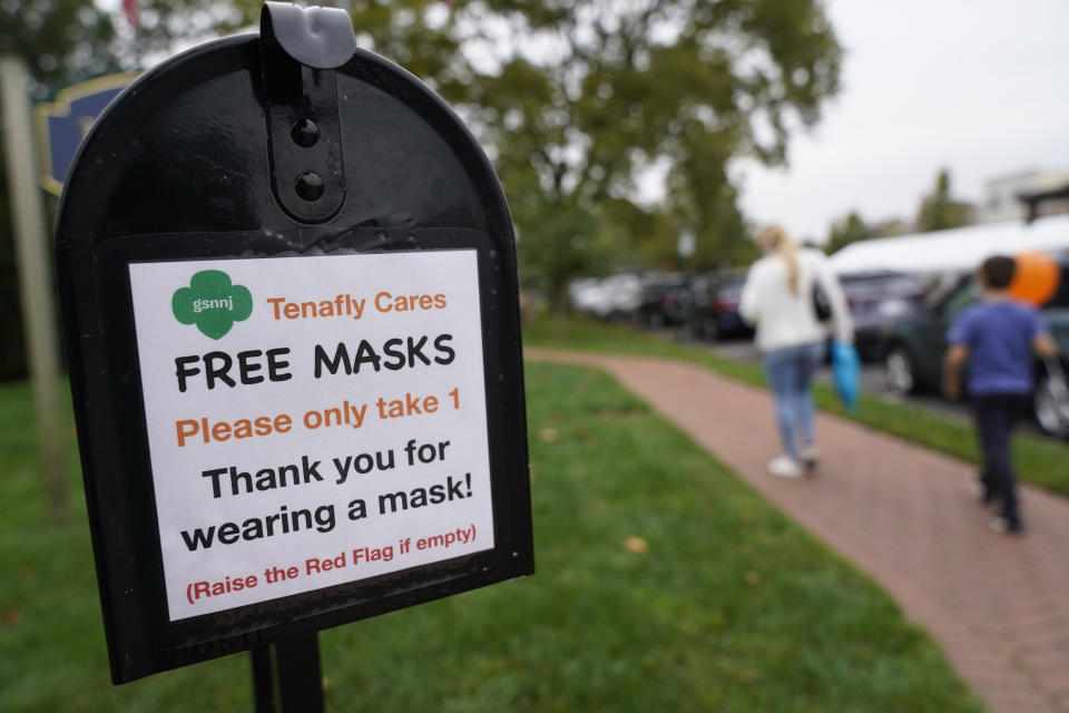 A mailbox containing free masks for pedestrians stands in the center of Tenafly, N.J., Thursday, Oct. 22, 2020. New Jersey's climbing number of COVID-19 cases are beginning to spread to northern counties around New York, Gov. Phil Murphy said Thursday. Essex, Union, Hudson and Bergen counties reported more than 100 new cases overnight, Murphy said, eclipsing recent hot spots in Ocean and Monmouth counties. (AP Photo/Seth Wenig)