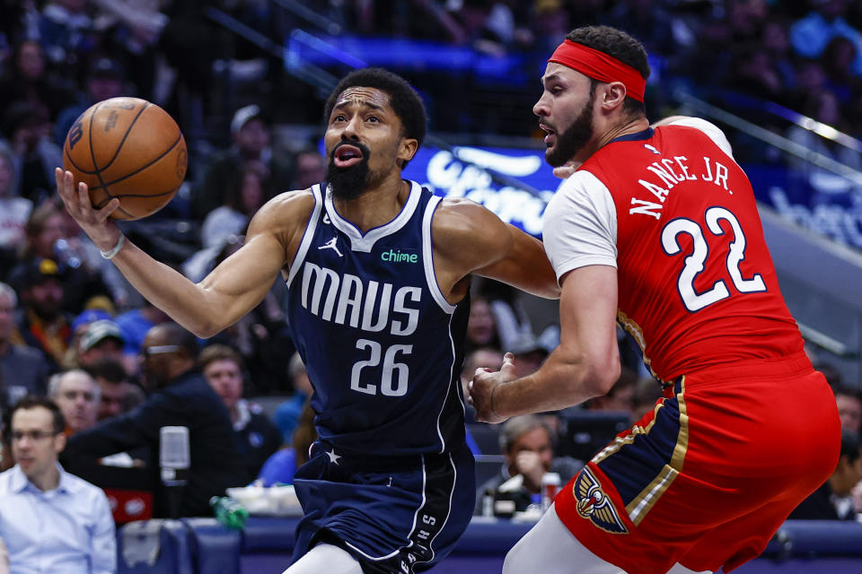 Dallas Mavericks guard Spencer Dinwiddie (26) battles New Orleans Pelicans forward Larry Nance Jr. (22) for space during the second half of an NBA basketball game, Thursday, Feb. 2, 2023, in Dallas. (AP Photo/Brandon Wade)