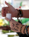 <p>A mourner leaves a candle on a makeshift memorial for the victims of Marjory Stoneman Douglas High School shooting in Parkland, Fla., on Feb. 15, 2018. (Photo: Rhona Wise/AFP/Getty Images) </p>