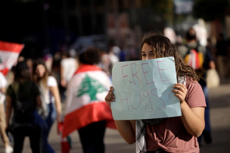 A woman offers free hugs as protesters leave after a demonstration organised by students during ongoing anti-government protests in Beirut