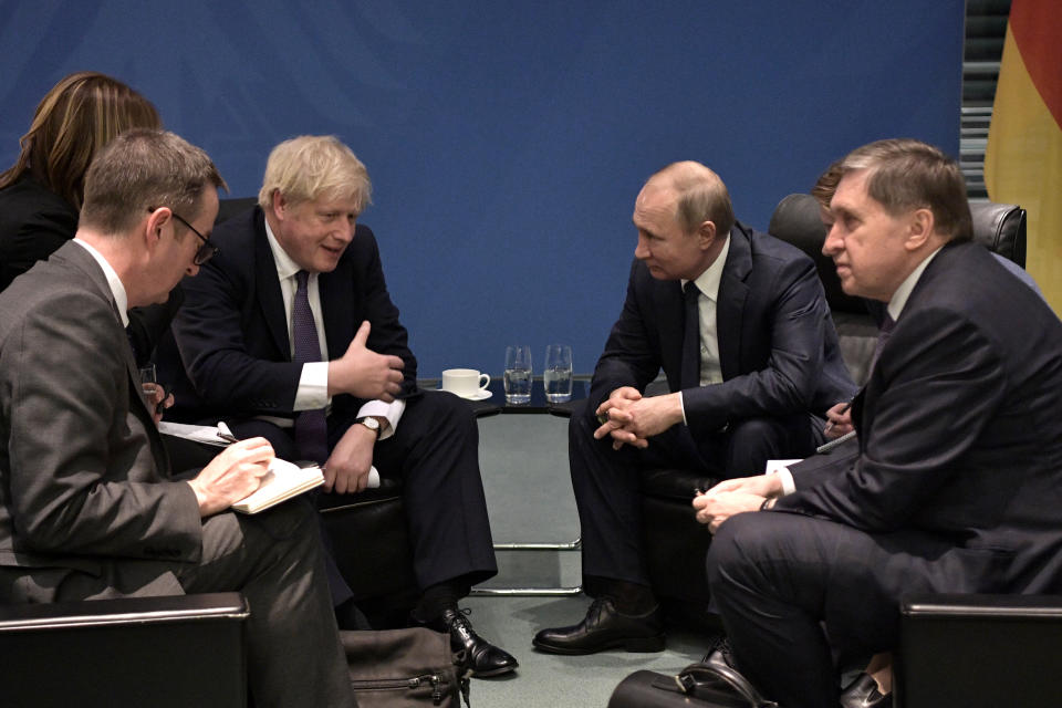 BERLIN, GERMANY - JANUARY 19, 2020: UK Prime Minister Boris Johnson and Russia's President Vladimir Putin (C L-R) talk during a meeting on the sidelines of an international summit on Libya; the summit is to discuss efforts to achieve peace and reconciliation between Libya's government and General Haftar; right: the Russian president's adviser Yuri Ushakov. Alexei Nikolsky/Russian Presidential Press and Information Office/TASS (Photo by Alexei Nikolsky\TASS via Getty Images)