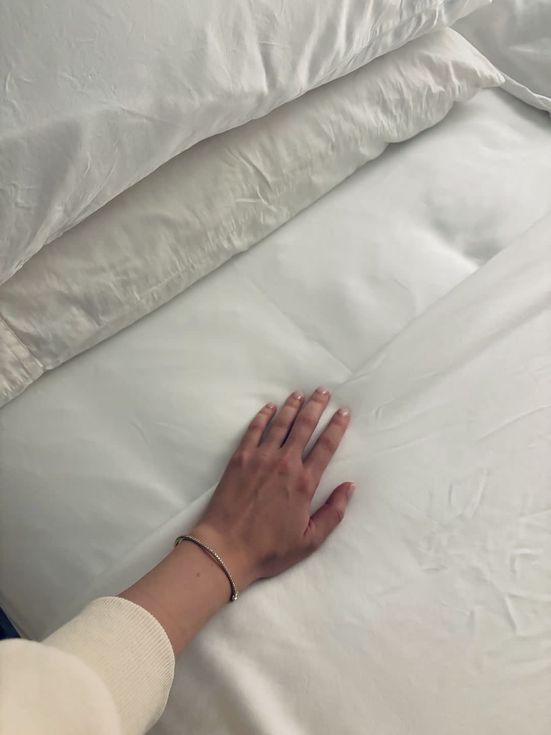 a hand on a bed