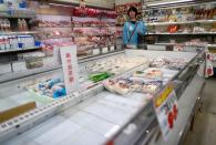 A shopper is seen next to empty shelves during an outbreak of the coronavirus disease (COVID-19), at a supermarket in Tokyo