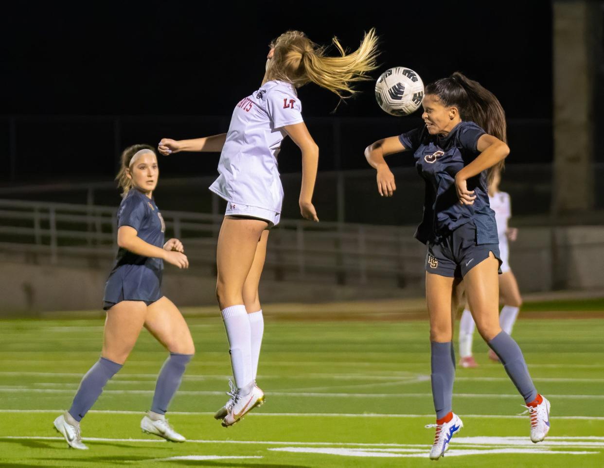 Dripping Springs' Hannah Gomez connects for a header during the Tigers' district match against Lake Travis on March 3. Dripping Springs beat Stony Point 9-0 to open the Class 6A soccer playoffs, and the Tigers will face Cibolo Steele in the area round on Tuesday.