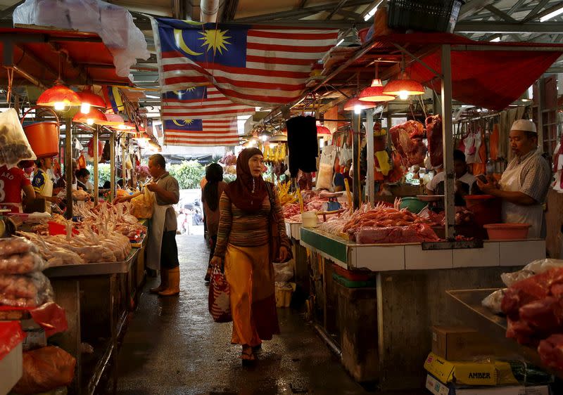 A woman shops in a wet market in Kuala Lumpur