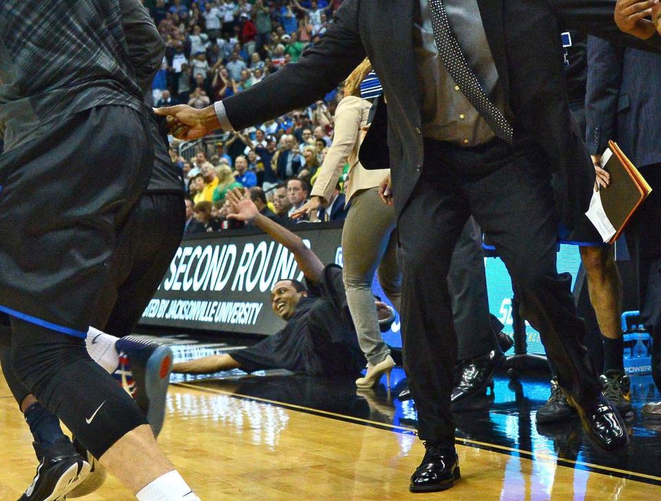 The Georgia State bench reacts to R.J. Hunter's 3-pointer as coach Ron Hunter cheers from the floor after falling off his stool during the 2015 NCAA Tournament in Jacksonville.