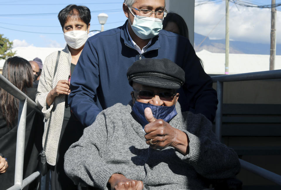 Anglican Archbishop Emeritus, Desmond Tutu gestures as he arrives to receive a shot of the COVID-19 vaccine, at the Brooklyn Chest Hospital in Cape Town, South Africa, Monday, May 17, 2021. South Africa has started its mass vaccination drive with the goal of inoculating nearly 5 million citizens aged 60 and above by the end of June. (AP Photo/Nardus Engelbrecht)