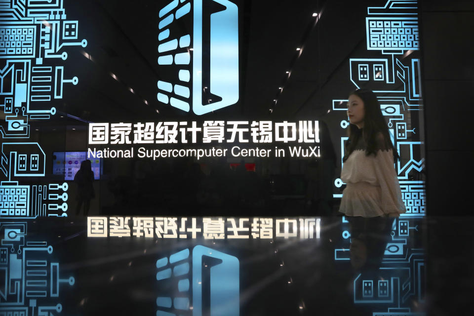 A woman walks in the hallway of the National Supercomputer Center in Wuxi, which hosts the Shenwei (Sunway) TaihuLight supercomputer, in Wuxi in eastern China's Jiangsu province on Aug. 29, 2020. The Biden administration has added seven Chinese supercomputer research labs and manufacturers to a U.S. export blacklist in a spreading conflict with Beijing over technology and security. (Chinatopix via AP)