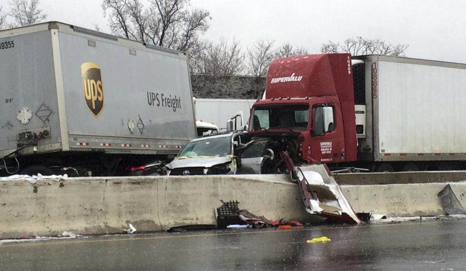 Wrecked vehicles lie next to the divider after a series of accidents on Interstate 95 in Baltimore, Md., on Saturday morning, Dec. 17, 2016, following an overnight ice storm. (Colin Campbell/The Baltimore Sun via AP)