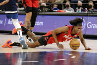 Houston Rockets guard Jalen Green falls after being fouled by Minnesota Timberwolves center Karl-Anthony Towns during the second half of an NBA basketball game Wednesday, Oct. 20, 2021, in Minneapolis. (AP Photo/Andy Clayton-King)