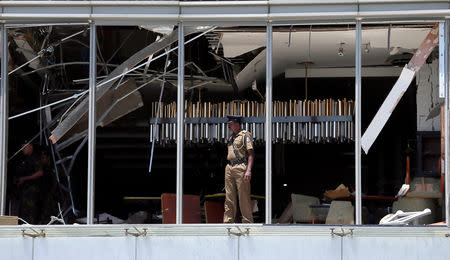 A police officer inspects the explosion area at Shangri-La hotel in Colombo, Sri Lanka April 21, 2019. REUTERS/Dinuka Liyanawatte