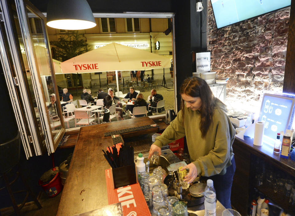 People gather and celebrate as bars, clubs and other establishments reopened in Poland after being closed for seven months, in Warsaw, Poland, Friday, May 14, 2021.(AP Photo/Czarek Sokolowski)