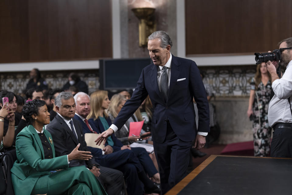 Starbucks founder Howard Schultz greets businesswoman Mellody Hobson, the current board chair of Starbucks Corporation, as he arrives at a crowded Senate Health, Education, Labor and Pensions Committee hearing room where he expects to face sharp questioning about the company's actions during an ongoing unionizing campaign, at the Capitol in Washington, Wednesday, March 29, 2023. (AP Photo/J. Scott Applewhite)